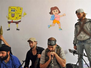 Fighters from the Syrian opposition rest at a former primary school in the center of Syria's restive northern city of Aleppo on 25 July (photo: Bulent Kilic | AFP)