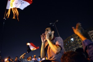 Thousands of Egyptians shout political slogans in support of the Egyptian president Mohamed Morsi as they celebrate his decision on the dismissal of former Egyptian Defence Minister and Field Marshall Hussein Tantawi, on 12 August at Tahrir square in Cairo AFP PHOTO/GIANLUIGI GUERCIA