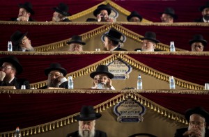 Ultra-Orthodox Jews convene at a sports stadium in Jerusalem July 30, 2012, in a celebration marking the completion of a seven-and-a-half year daily study-cycle of the entire Babylonian Talmud.Tens of thousands of Jews worldwide take part in the 'Daf Yomi' project literally a 'daily page' of study of the ancient text of Jews law and tradition, perhaps the most central composition of rabbinic literature.AFP PHOTO/MENAHEM KAHANA