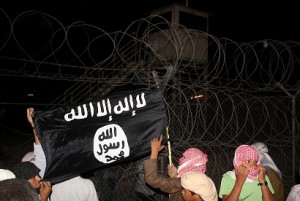 Bedouin protesters wave an Al-Qaeda-affiliated flag near a watch tower in Egypt's Sinai on 14 September after they stormed a compound of the Multinational Force and Observers to protest against a film mocking Islam AFP PHOTO / STRINGER