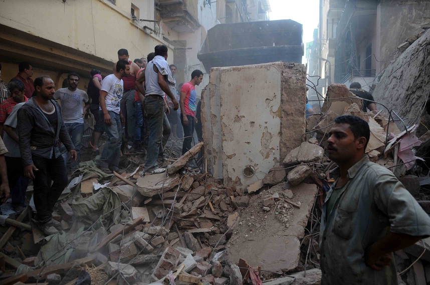 Rescuers try to clear the debris from a recent building collapse in the Shubra area of Cairo (File photo) Mohamed Omar