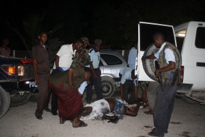 Police gather at the scene of an attack after two suicide bombers blew themselves up in a restaurant in Mogadishu’s Hamarweyne district AFP PHOTO / ABDURASHID ABDULLE ABIKAR