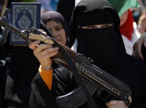 A Syrian woman holds an AK-47 during an anti-Bashar Assad protest after Friday prayers on the outskirts of Idlib, Syria AFP PHOTO