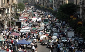 Egyptians mix road and market space in crowded road conditions in Cairo AFP PHOTO / MAHMUD HAMS