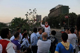 A member of the âBe a manâ campaign talks on the streets of Cairo during a previous anti-sexual harassment event. (File photo, Isstargel group)