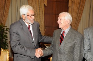Jimmy Carter shakes hands with constituent assembly head Hossam El-Gheriany at the Shura Council. (PHOTO BY MOHAMED OMAR)