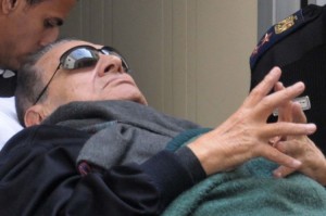Former president Hosni Mubarak lies on a stretcher as he leaves court (File photo) AFP PHOTO