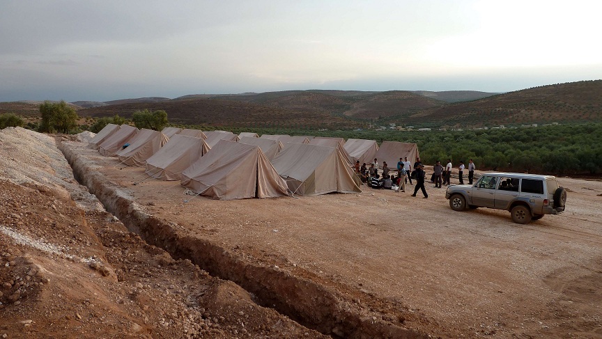 Syrian volunteers set up tents for refugees in the northwestern Syrian village of Qah AFP PHOTO / HERVE BAR