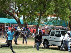Striking miners run away as South African police officers fire rubber bullets, stun grenades and tear gas to disperse miners who were trying to prevent a rally organised by the Congress of South African Trade Unions. (AFP PHOTO / STEPHANE DE SAKUTIN)
