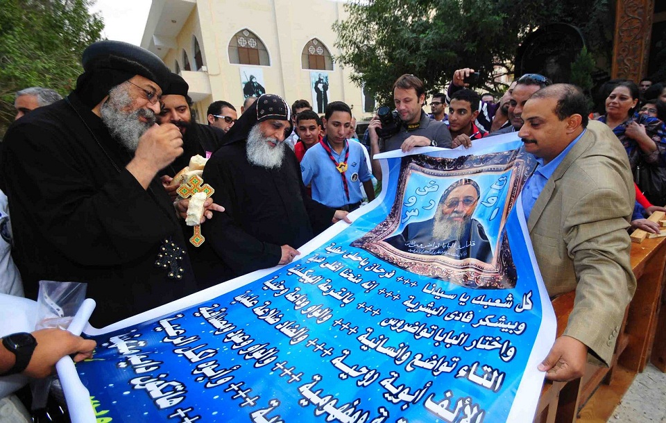 Worshippers present Bishop Tawadros with a new banner celebrating his ascension to the papacy Hassan Ibrahim