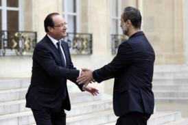 French President Francois Hollande (L) welcomes Syrian opposition chief Ahmed Moaz Al-Khatib in Paris Saturday. (AFP PHOTO / Kenzo Tribouillard)