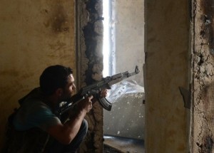A Syrian rebel aims his weapon during clashes with government forces in the Saif al-Dawla district of the northern city of Aleppo on October 5. (AFP / FILE PHOTO / TAUSEEF MUSTAFA)