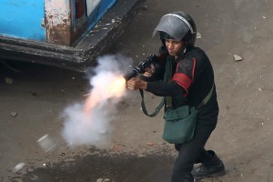 An Egyptian police officer fire tear gas at demonstrators in Cairo AFP Photo / Khaled Desouki