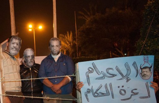 Protesters wear masks depicting Mohamed Morsi (left) and other Egyptian leaders at a mock trial in Port Said on Friday. (AFP Photo)