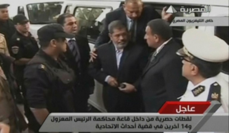 A screen grab from state TV showing former President Mohamed Morsi on his fIrst day of trial (AFP File Photo)