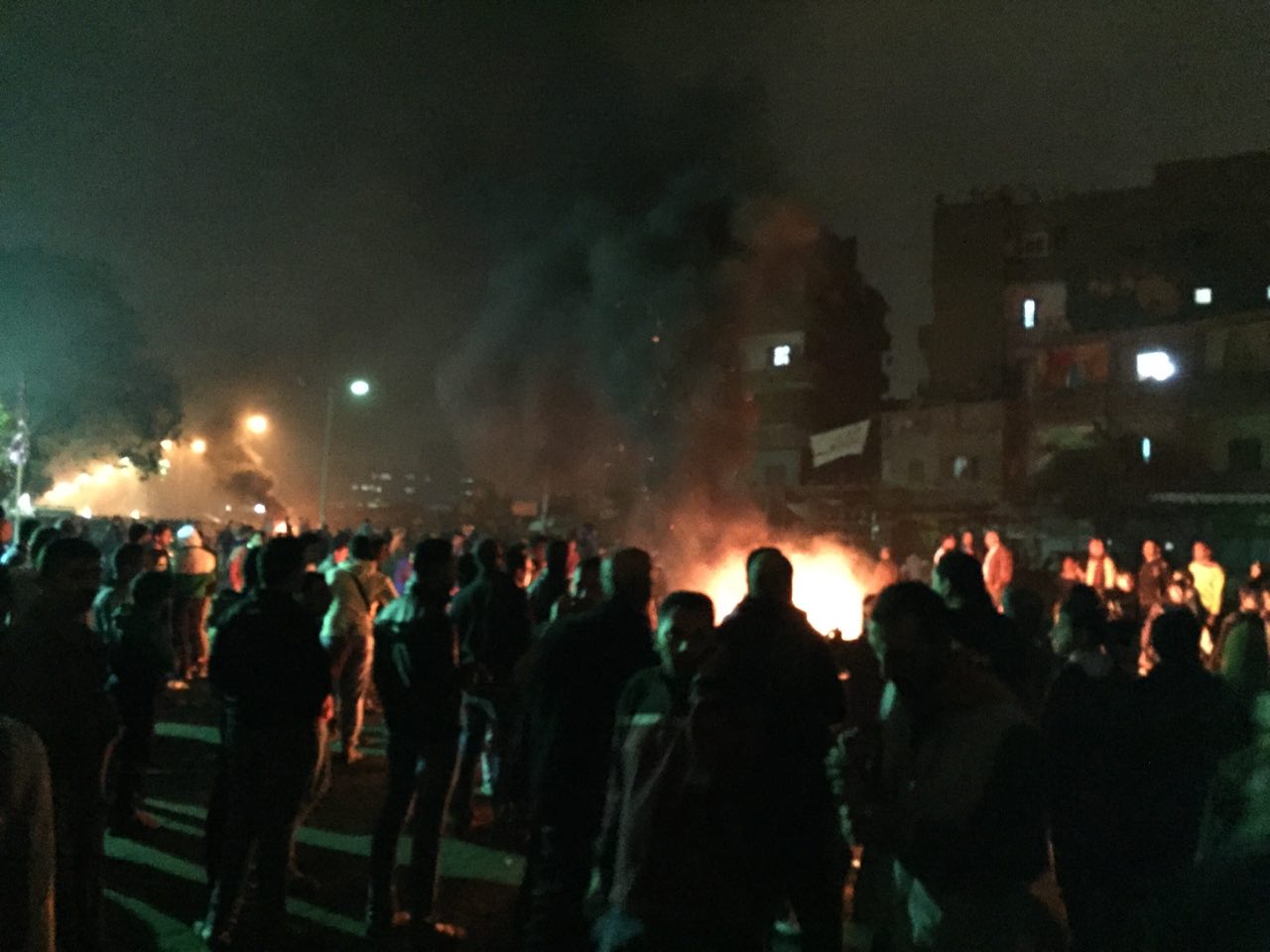 Clashes Sunday at Matariya Square left at least 12 protesters dead. Photo shows a gathering of demonstrators around a fire. Photo provided to Daily News Egypt by a protester