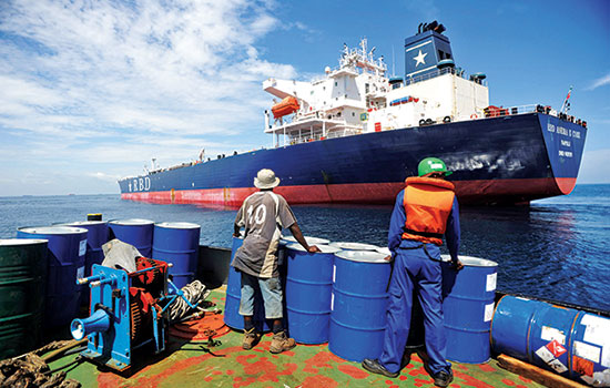 A crew member prepares to board the RBD Anema E Core in the Lomé anchorage; the tanker was hijacked by pirates in Benin in 2011 (IRIN/Daniel Hayduk)
