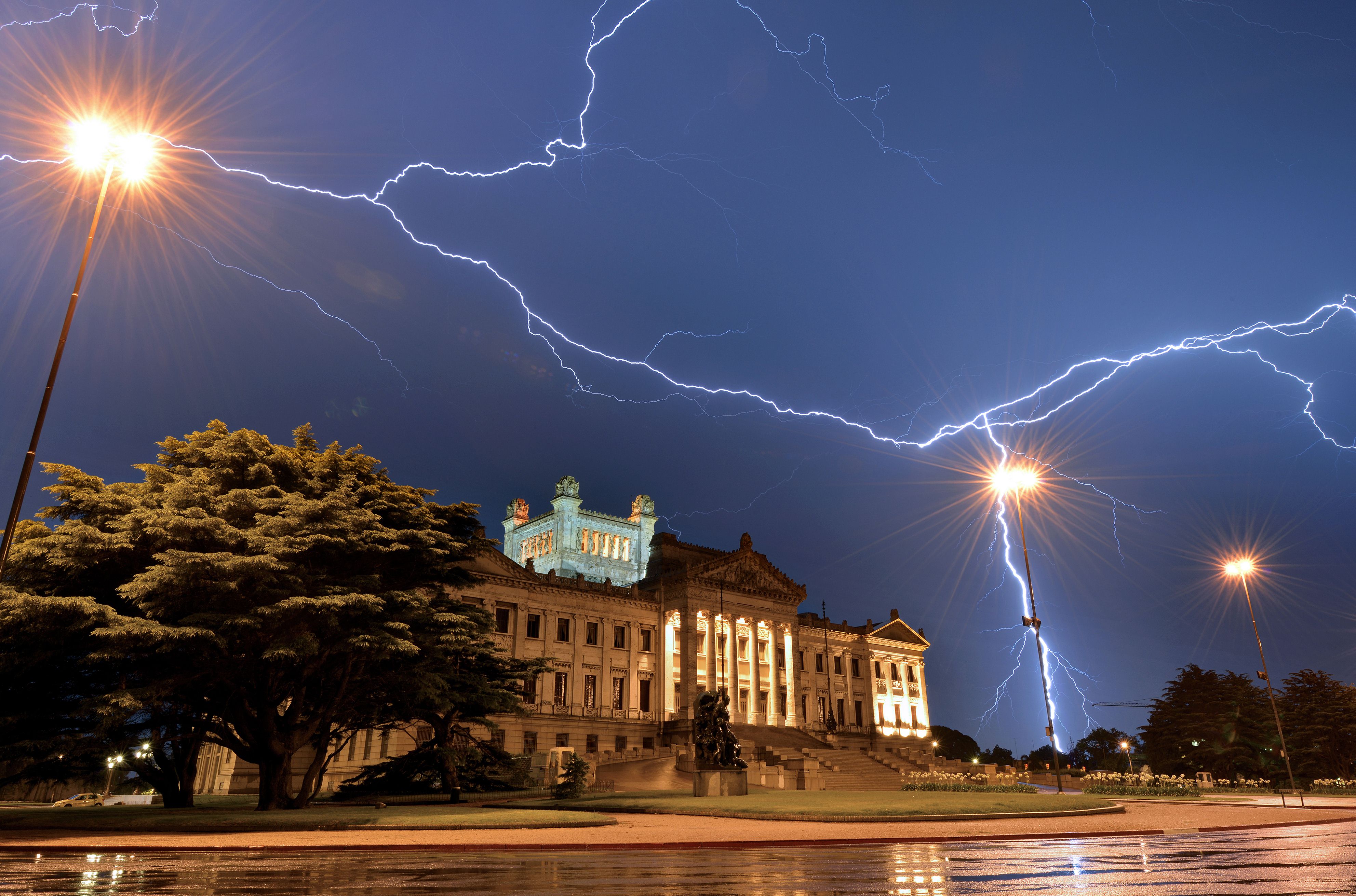 Lightning streaks across the sky of Montevideo, over the Legislative Palace -- seat of the Uruguayan Government -- during a thunderstorm early on 10 January 2014. (AFP PHOTO / MARIANA SUAREZ)