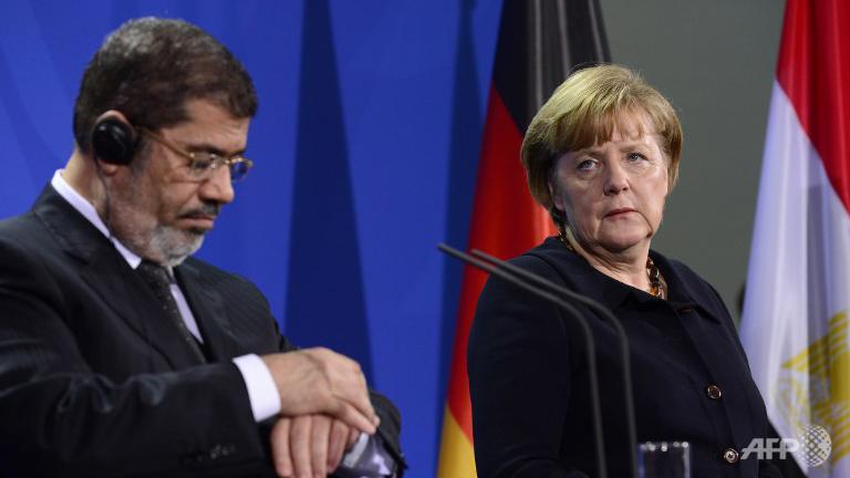 Morsi’s and Merkel’s meeting presumed the resumption of negotiations on NGOS (AFP Photo)