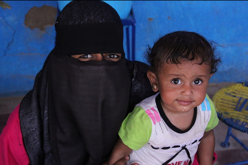 A woman poses with her child during the celebrations (Photo by Aurora Ellis)