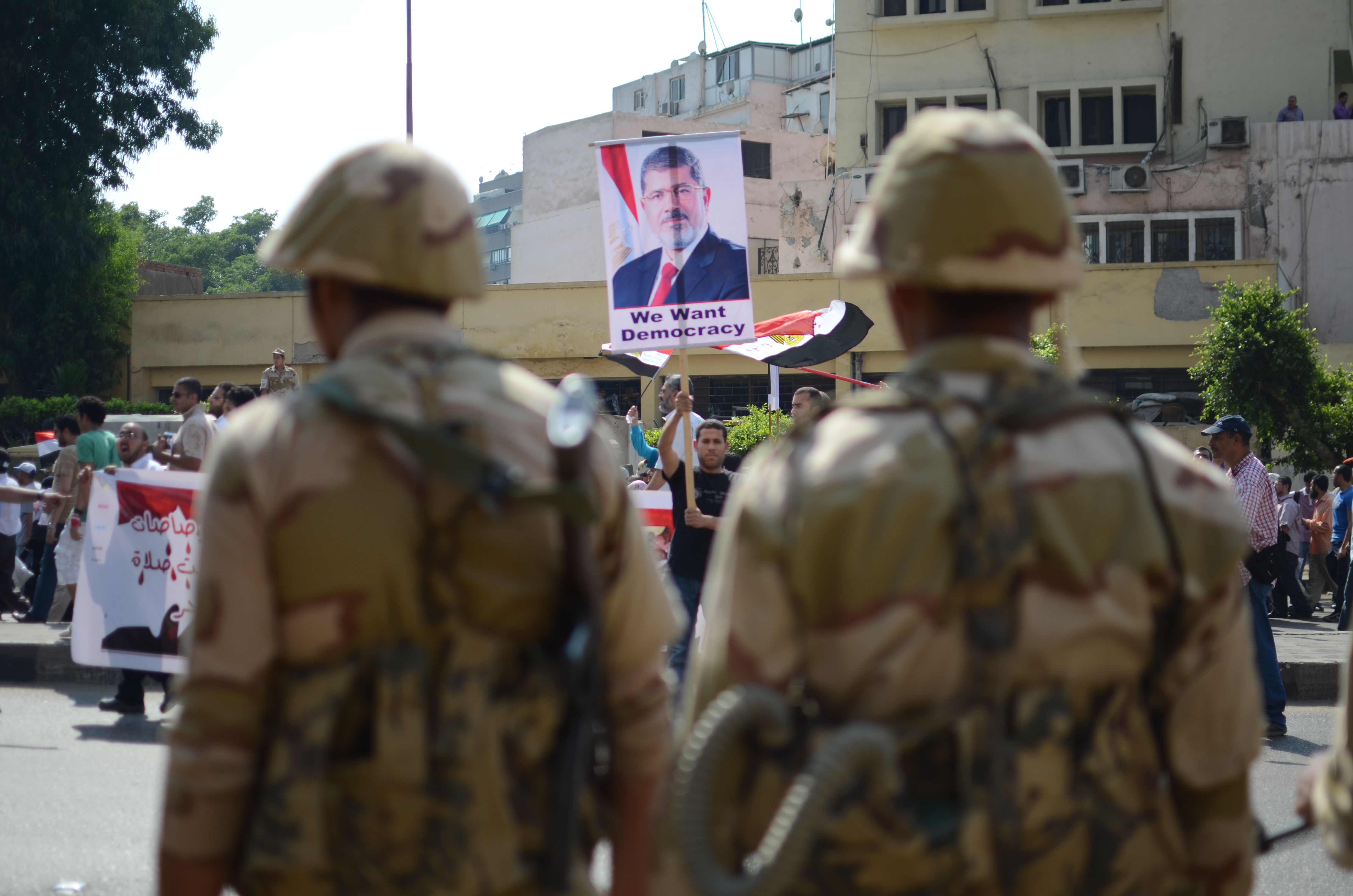 A Protester Faces Army Personnel In Front Of Gize Security Directorate