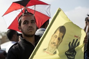 A supporter of Egypt's deposed Islamist president Mohamed Morsi is pictured outside the police academy in Cairo on 4 November 2013 (AFP/File)