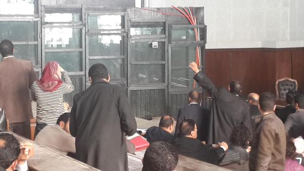 Relatives of defendants in 25 January trial case on 3 March managed to enter court,wave to them through dark glass cage ( Photo by Amira El-Fekki)