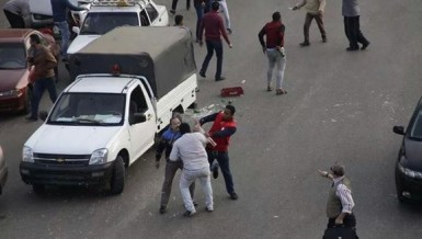 Men brandishing broken glass bottles attacked demonstrators during a small protest next to Tahrir Square on Friday evening (Photo by Bassam Morsy)