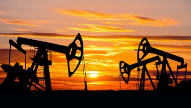 Industrial landscape. US Oil Field. Oil pumps against the setting sun. Daily News Egypt