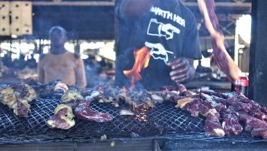 Man grilling Namibian cuisine kapana (grilled meat) Daily News Egypt