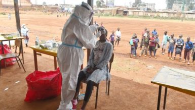 A health worker takes a swab sample for COVID-19 test from a girl in Nairobi, capital of Kenya, on Oct. 17, 2020. (Photo by Joy Nabukewa-Xinhua)