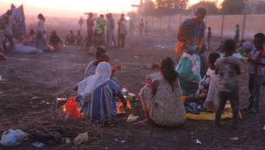 Ethiopian refugees fleeing clashes in the country's northern Tigray region, rest and cook meals near UNHCR's Hamdayet reception centre after crossing into Sudan. Photo credit: © UNHCR- Hazim Elhag
