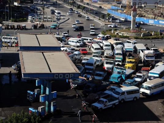Vehicles wait at a gas station amid fuel shortages after 25 January Revolution