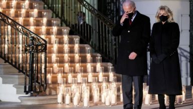 Candles were lit at the White House South Portico at sunset Monday, a day on which the number of Americans who died from COVID-19 broke the staggering record of 500,000.