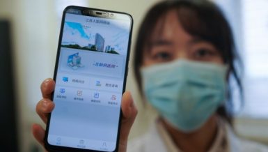 A staff member displays the mobile application of the Internet Hospital of Jiangsu Province Hospital in Nanjing, east China's Jiangsu Province, Feb. 7, 2020. (Xinhua/Ji Chunpeng)