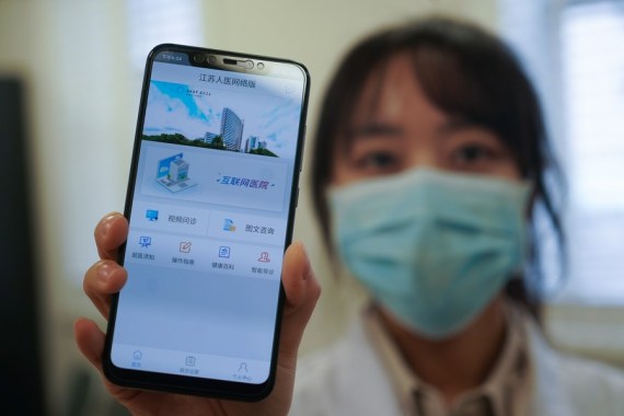 A staff member displays the mobile application of the Internet Hospital of Jiangsu Province Hospital in Nanjing, east China's Jiangsu Province, Feb. 7, 2020. (Xinhua/Ji Chunpeng)